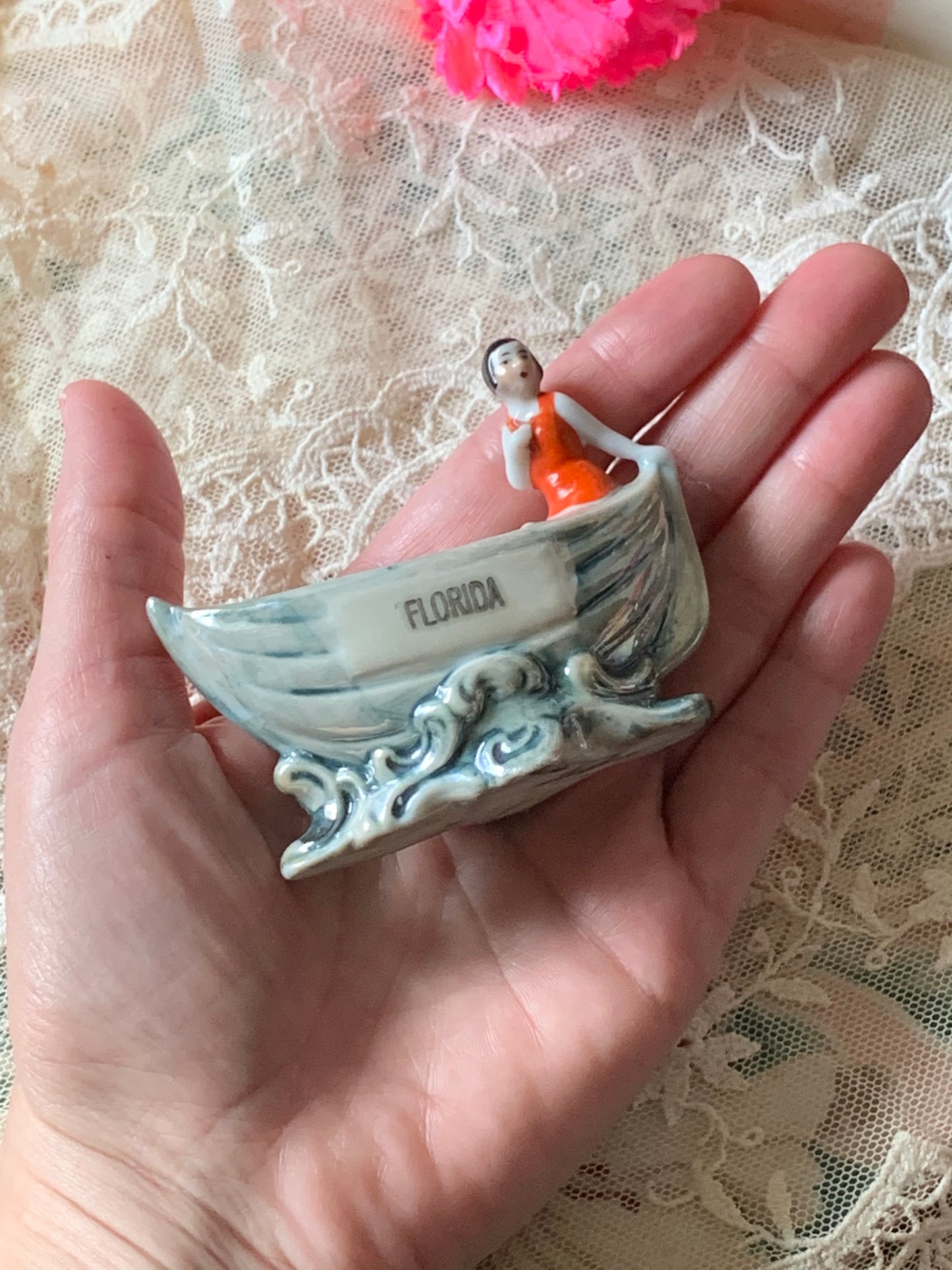 Vintage miniature bathing beauty in boat