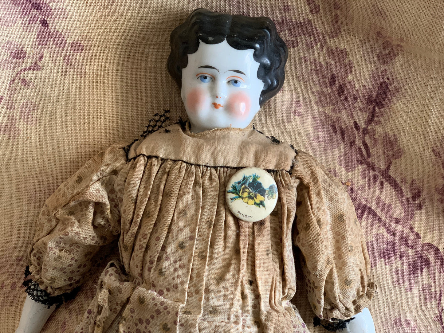 Antique china doll with blue boots