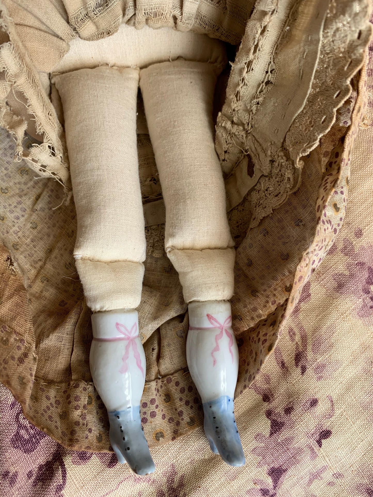 Antique china doll with blue boots