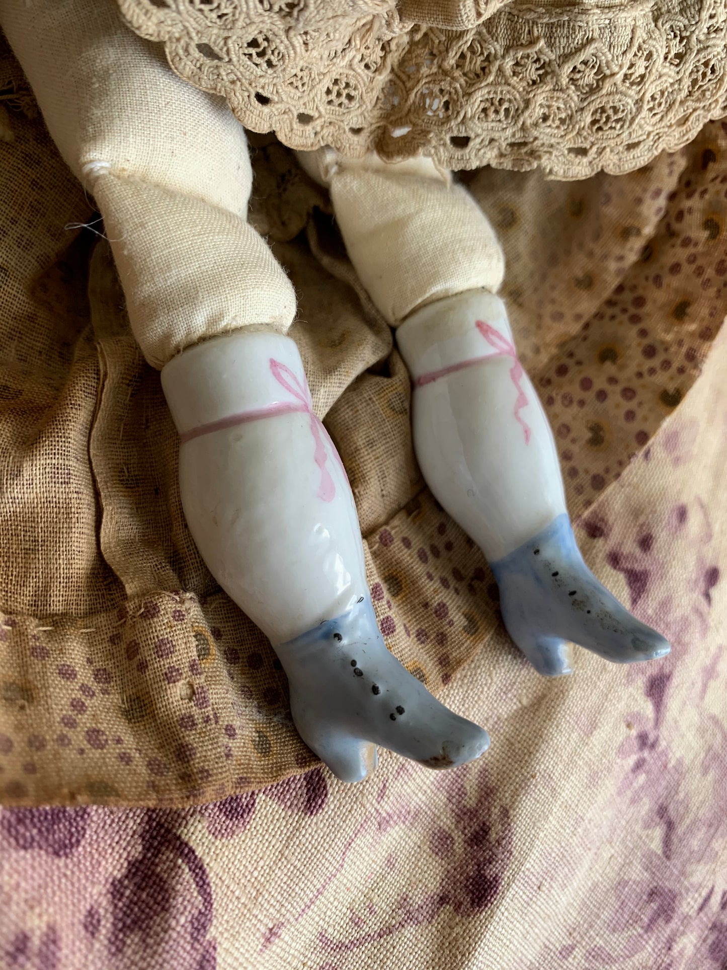 Antique china doll with blue boots