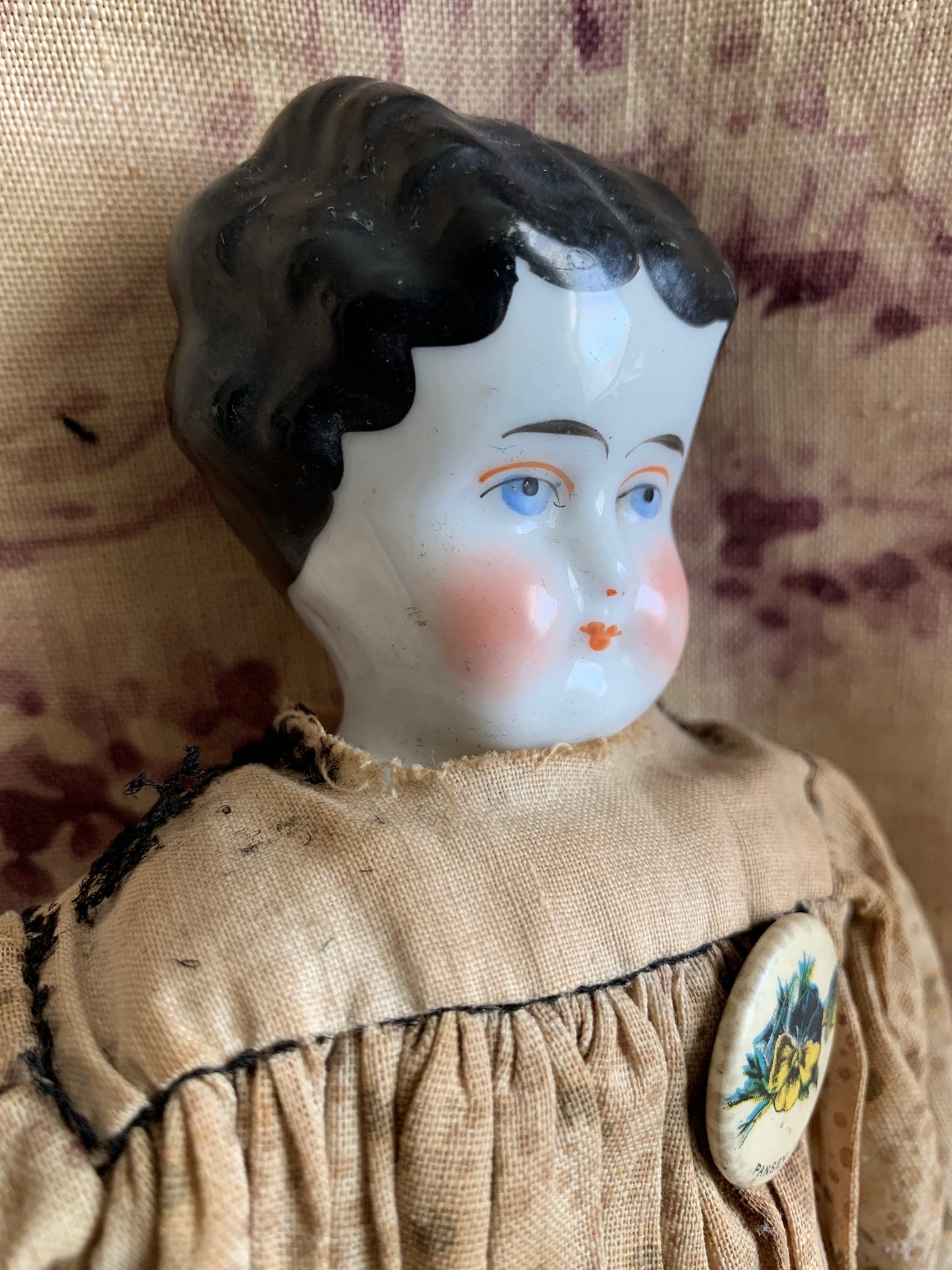 Antique china doll with blue boots