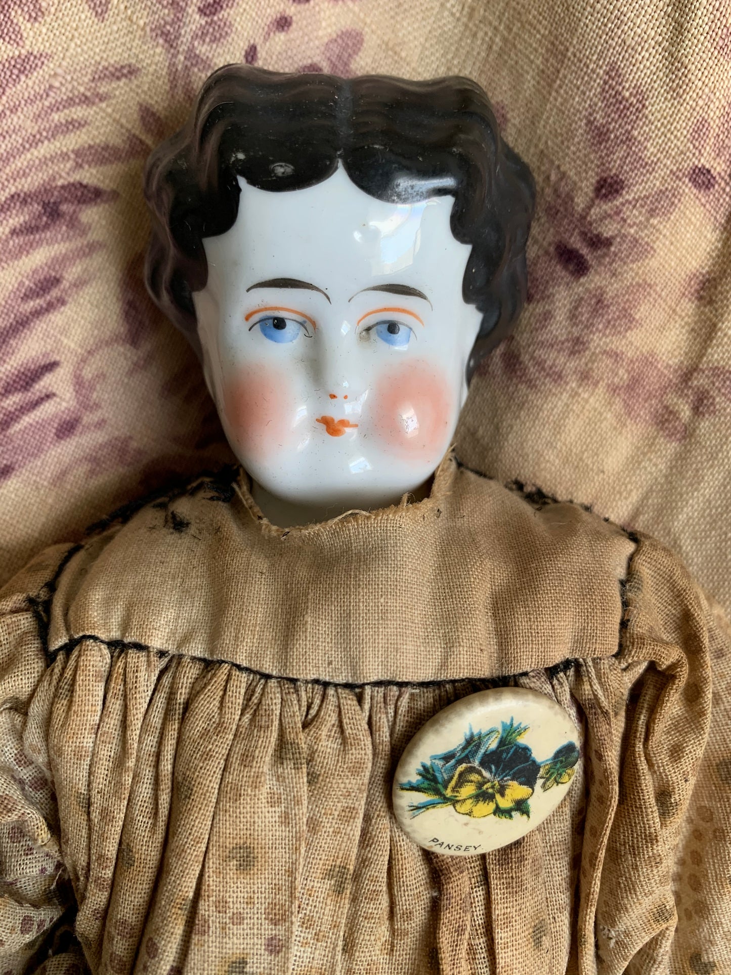 Antique china doll with blue boots