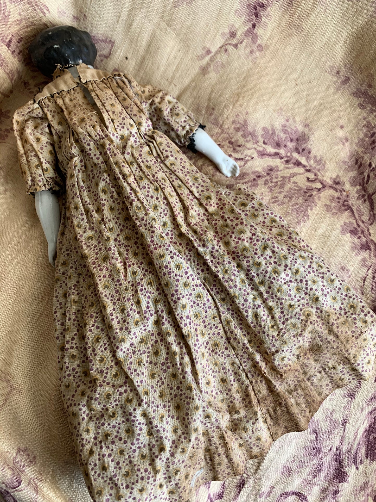 Antique china doll with blue boots