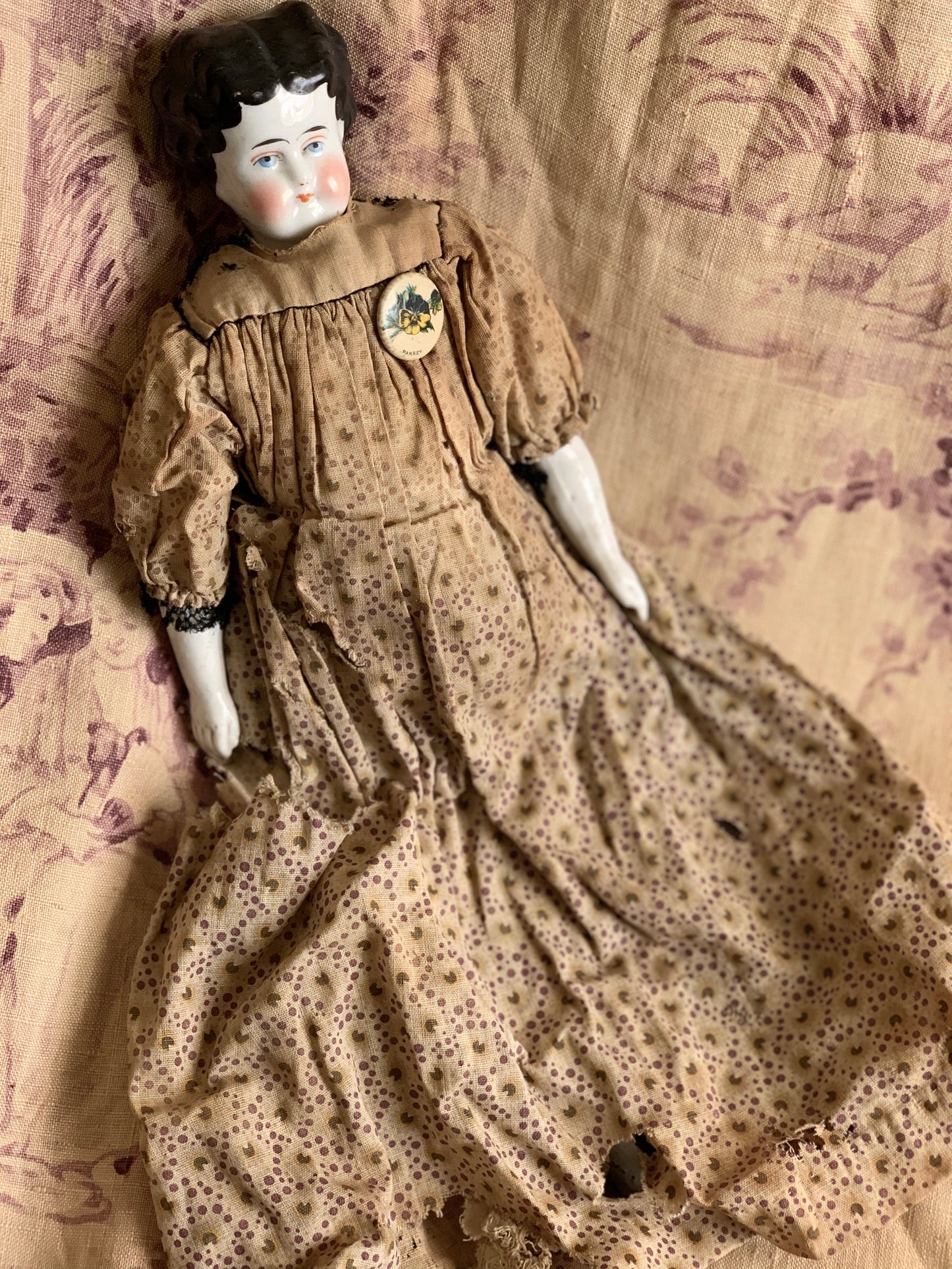 Antique china doll with blue boots