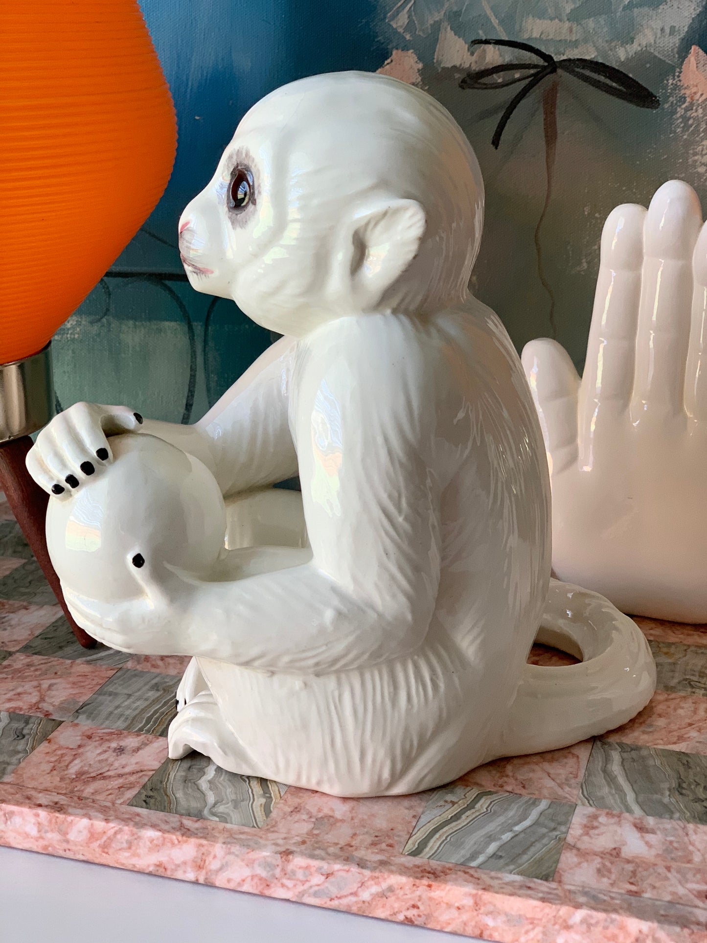 Vintage white capuchin monkey holding ball Italian statue