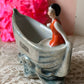 Vintage miniature bathing beauty in boat