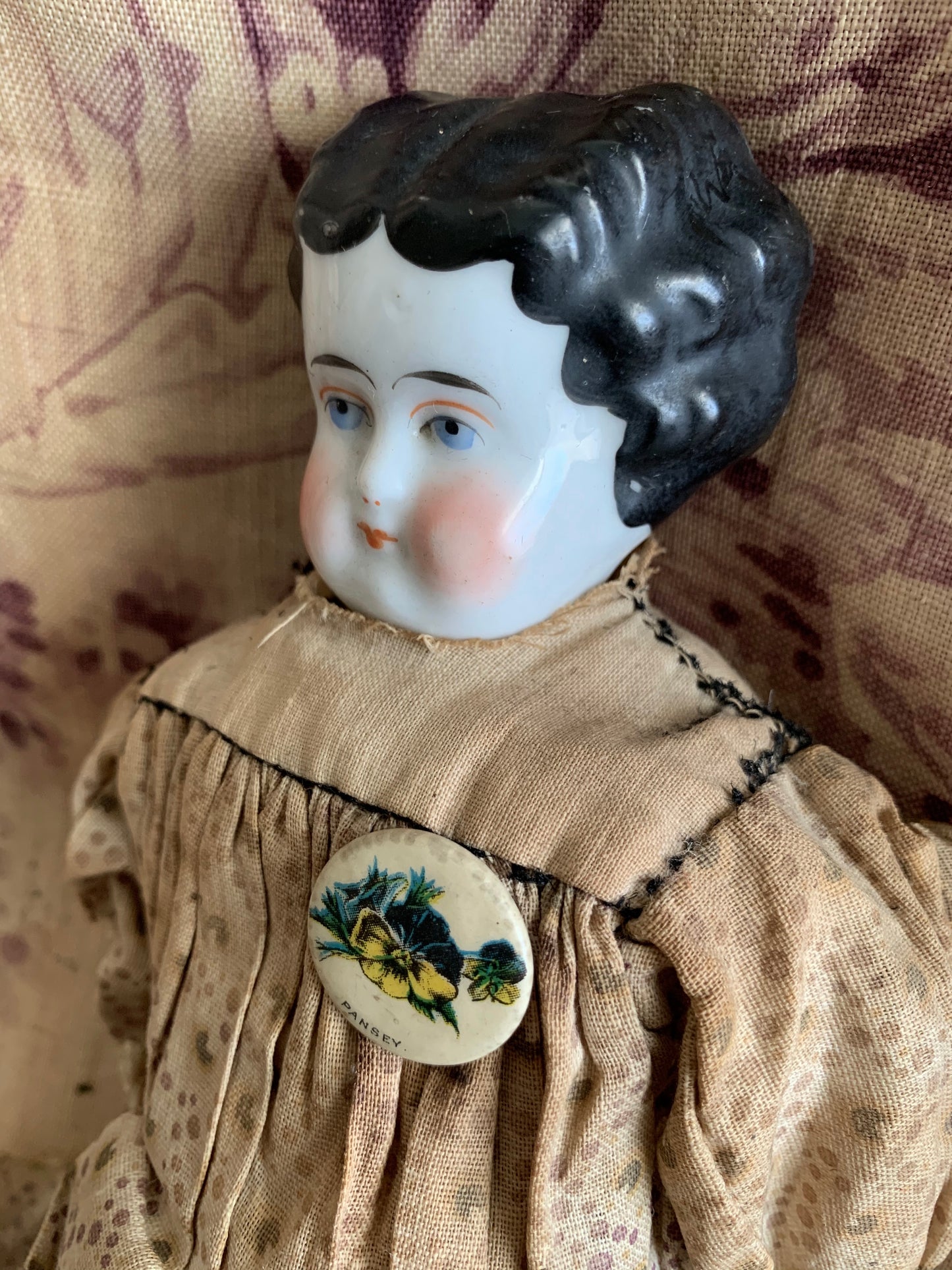 Antique china doll with blue boots