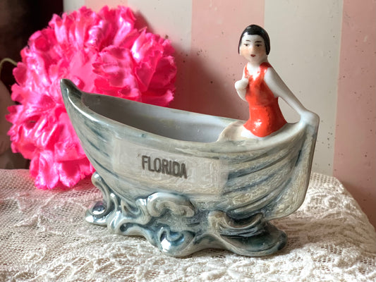 Vintage miniature bathing beauty in boat