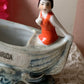 Vintage miniature bathing beauty in boat