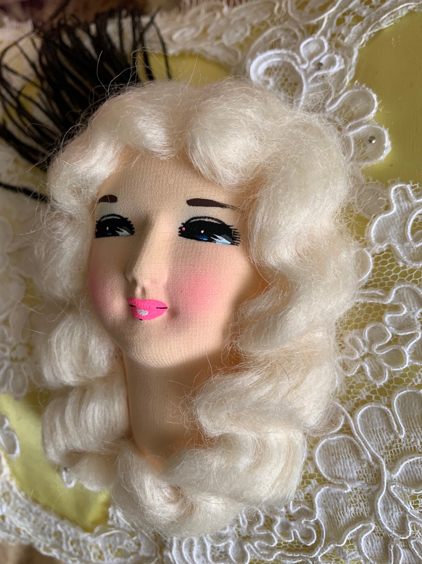 Assembled vintage doll face pillow