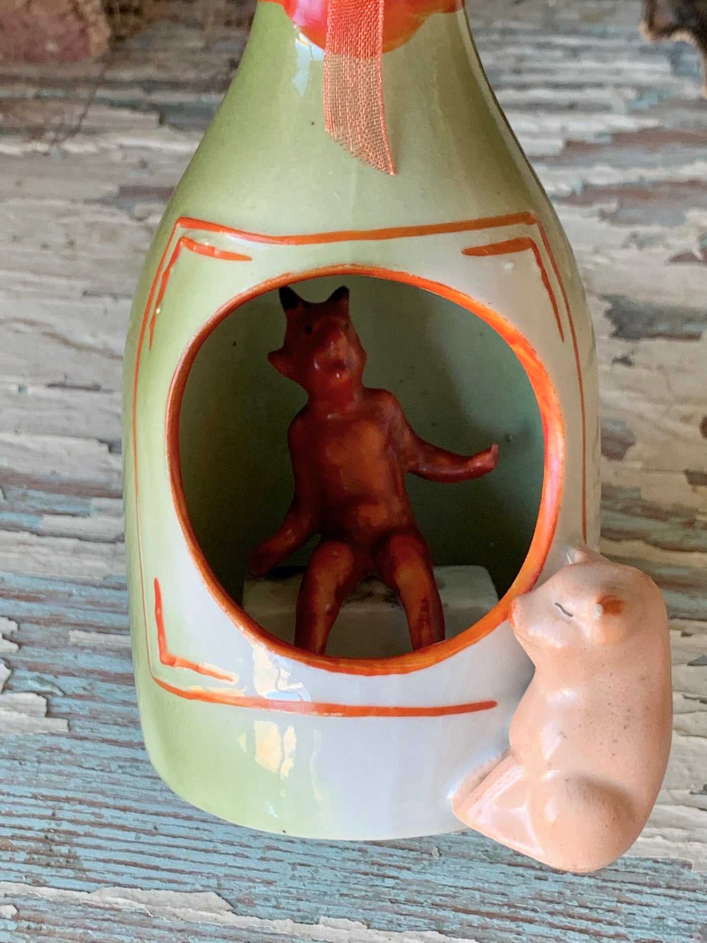 Antique porcelain devil and pig bottle figurine