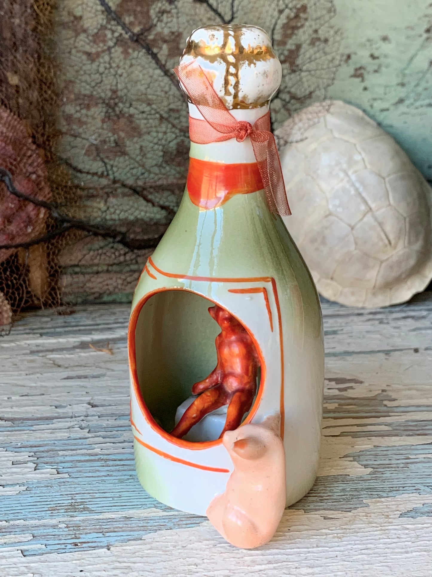 Antique porcelain devil and pig bottle figurine
