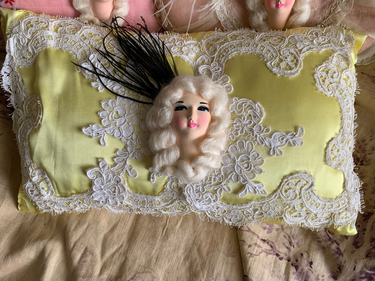 Assembled vintage doll face pillow