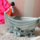 Vintage miniature bathing beauty in boat