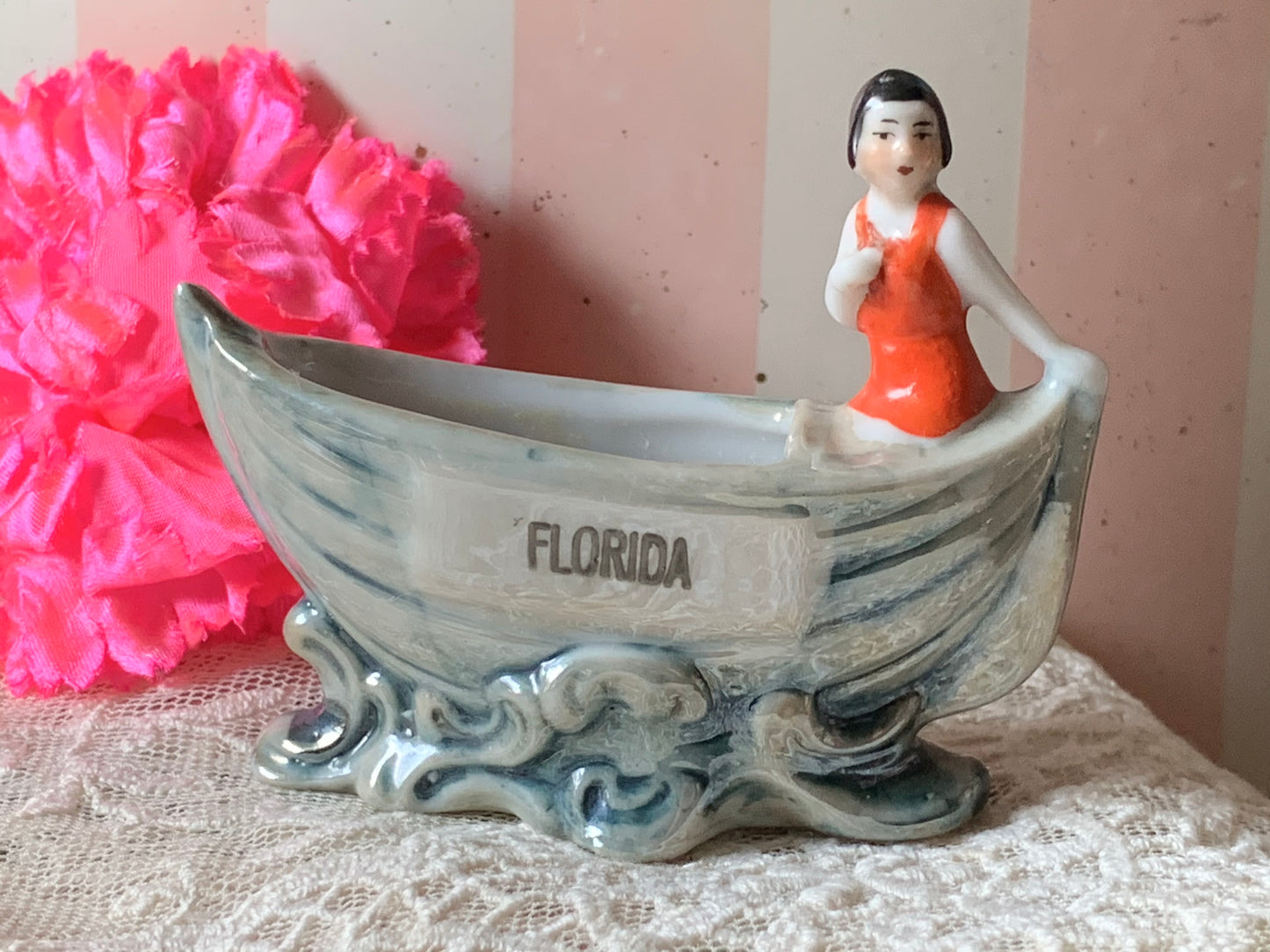 Vintage miniature bathing beauty in boat